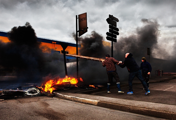 Boulogne-sur-Mer, France.  Striking fisherman, protesting about the low price of fish, block the main road artery in the port's fish processing district, Capécure, with burning tyres