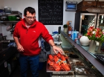 Calum Greenhalgh and steamed lobsters in his shop and cafe 'Fresh from the Sea', which he runs with his wife Tracey. Port Isaac, North Cornwall.