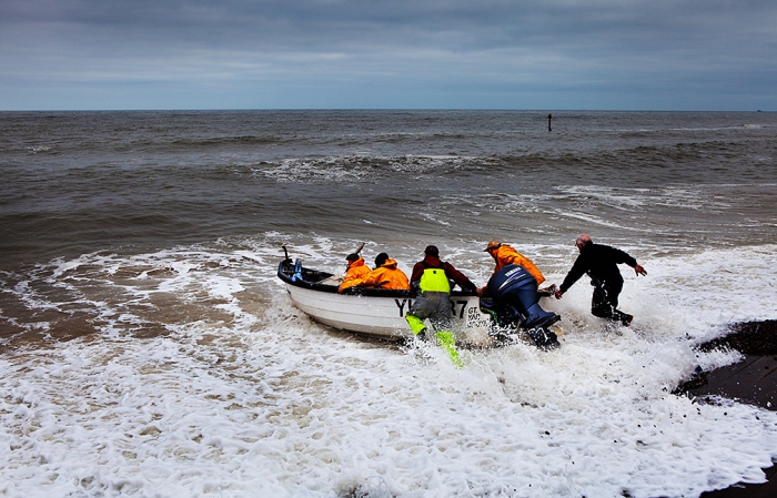 Fishermen launching their boat in Sheringham, north Norfolk, March 2013