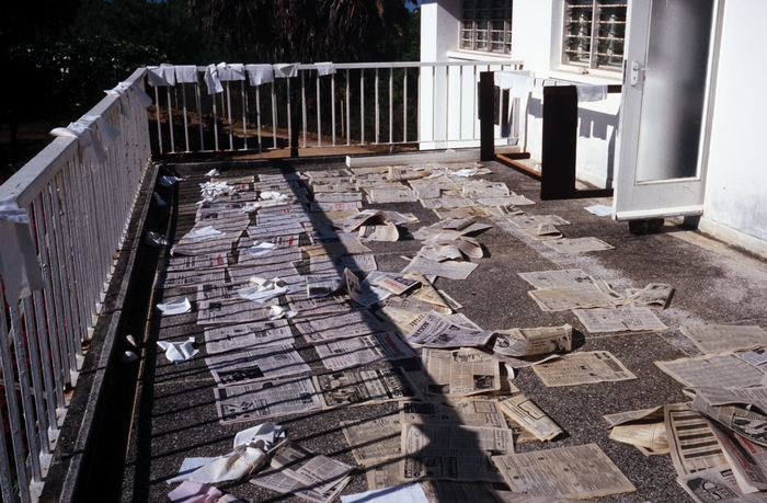 Terrace of the Belgian House where news papers with algae are drying