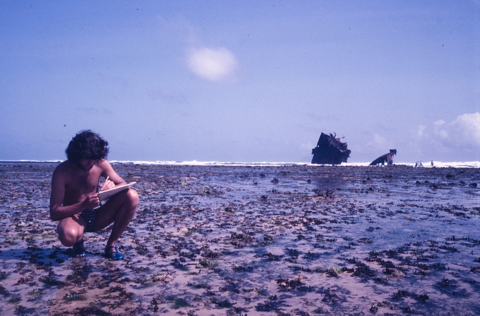 Tom Beeckman taking notes on plexiglass plate of the algae around the boat wreck on fringing reef